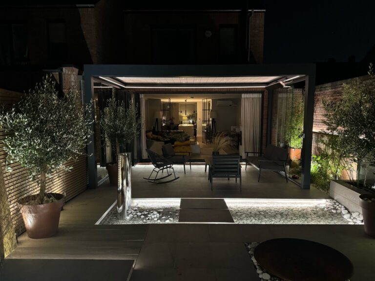 pergola with lighting and bladed roof at nighttime