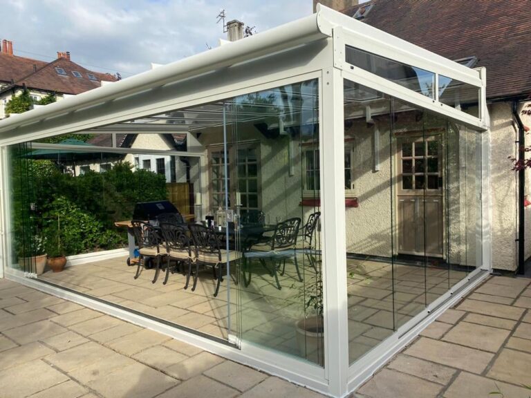 white pergola attached to an old victorian house