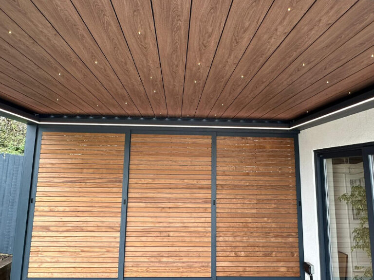 small pergola with wooden doors and ceiling with lighting